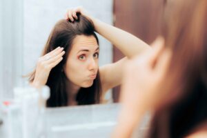 A person checking hairline