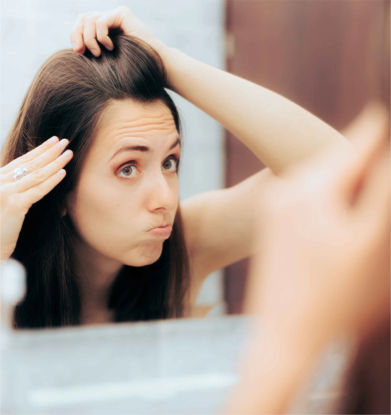 woman looking for hair loss